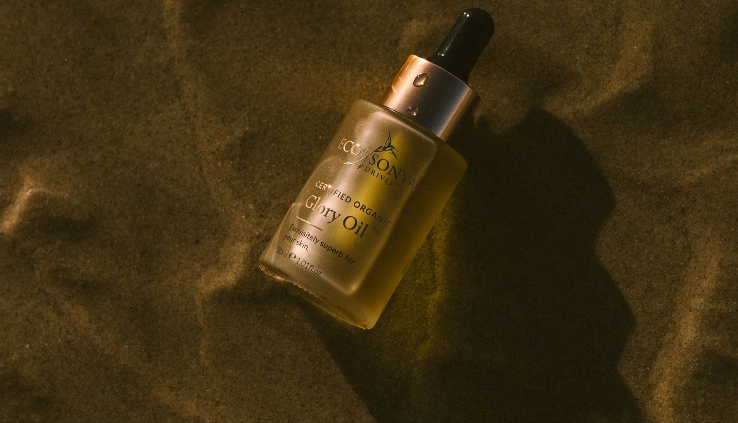 Eco by Sonya natural organic Glory Oil for face and body gold on beach